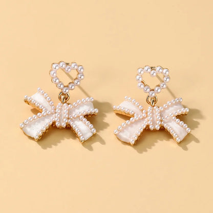 1 Pair Elegant Classic Style Streetwear Bow Knot Inlay Alloy Artificial Pearls Drop Earrings