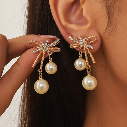 1 Pair Elegant Streetwear Bow Knot Inlay Alloy Artificial Pearls Gold Plated Drop Earrings