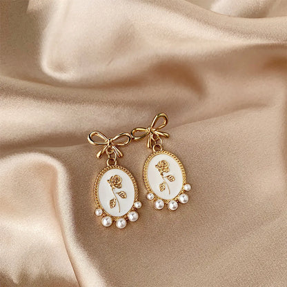 1 Pair Vintage Style Bow Knot Enamel Plating Inlay Alloy Artificial Pearls Gold Plated Drop Earrings