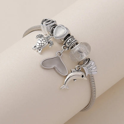 Casual Korean Style Tortoise Dolphin Heart Shape Alloy Copper Hollow Out Inlay Acrylic Women'S Bracelets