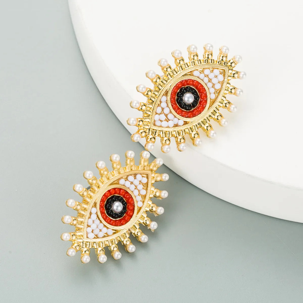 Retro Devil's Eye Alloy Inlaid Pearl Rhinestone Earrings