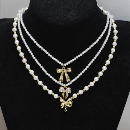 Simple Style Classic Style Bow Knot Imitation Pearl Copper Wholesale Pendant Necklace